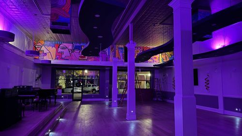 Crescent Station’s long bar beneath its vaulted, mural-painted ceiling.