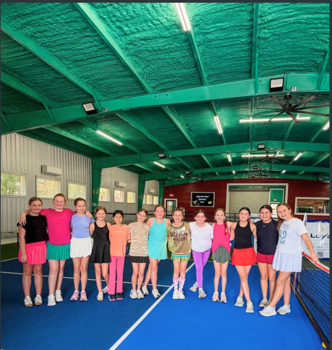 A group of friends playing indoor pickleball.