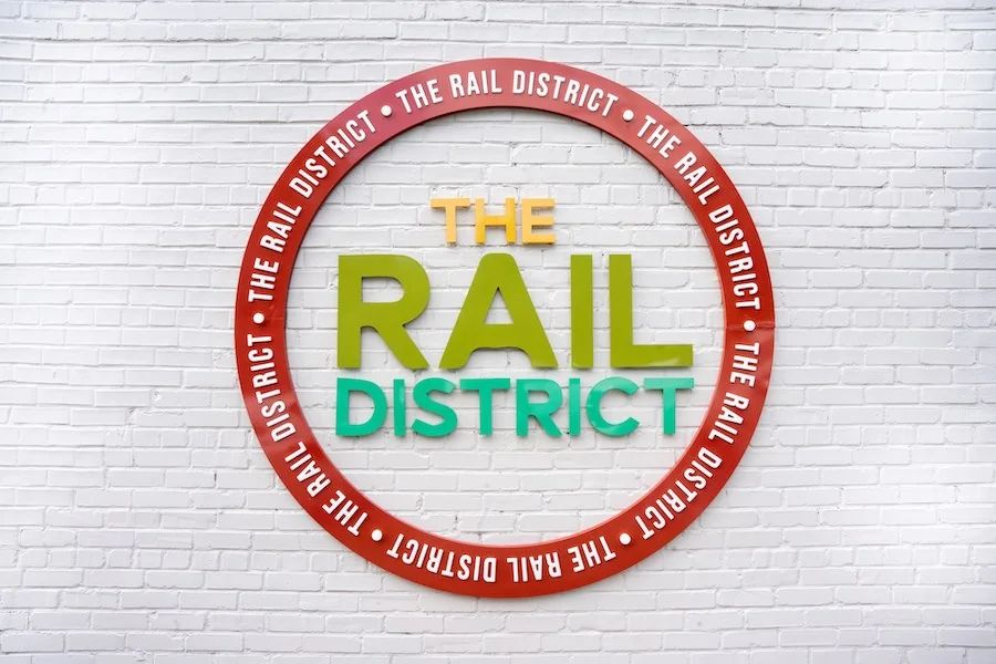 The circular 'THE RAIL DISTRICT' wall sign.