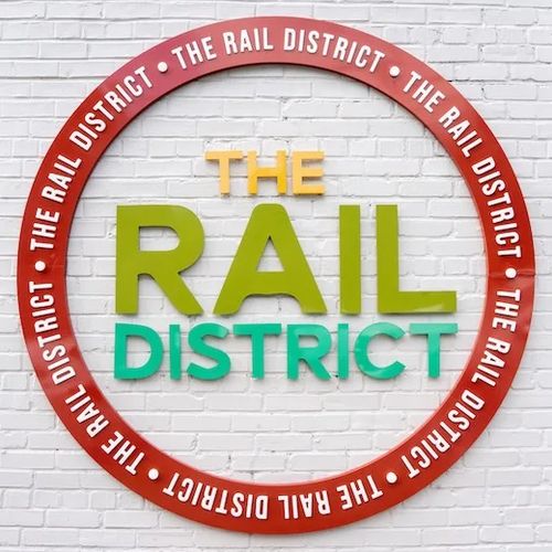 The circular "THE RAIL DISTRICT" wall sign.