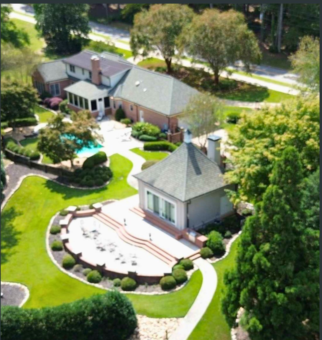 Aerial photo of an estate and pool.